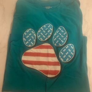 Teal color t-shirt with red white blue giant paw